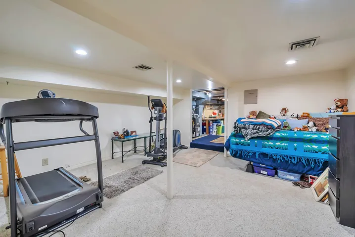 Recessed ceiling lighting, carpeted flooring, and exposed support columns