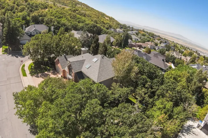 Brick exterior home with a gabled roof, multiple skylights, and a two-car garage