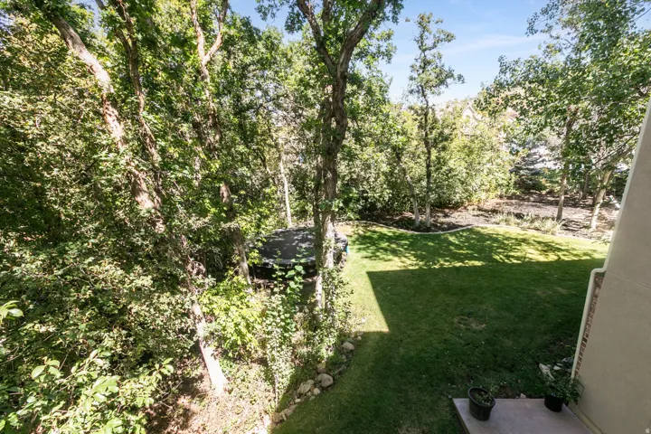 Lush, treed surroundings with a manicured lawn area