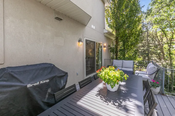 Exterior stucco siding with a wood-finish deck