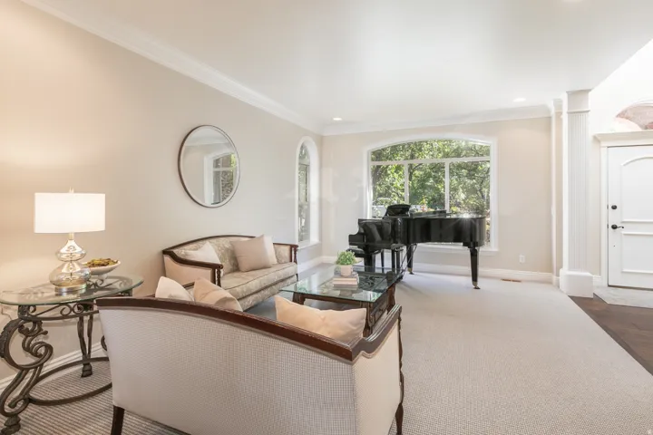 Arched window, recessed lighting, crown molding, cased entry, and carpeted flooring