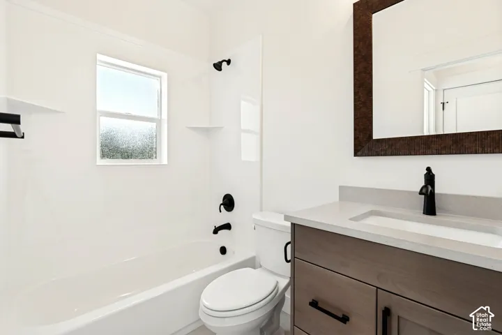 White tub with black fixtures, a window, and integrated shelving