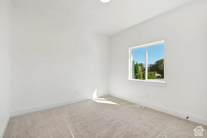 Neutral color palette with white walls and light-toned carpeting