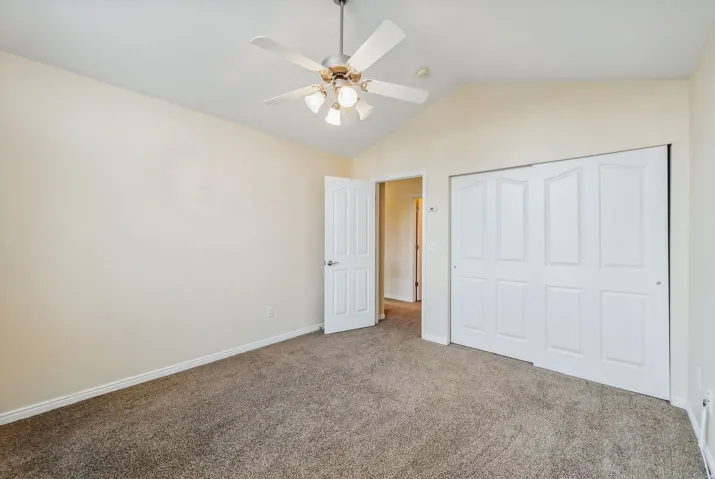 Vaulted ceiling with an attached ceiling fan and light fixture