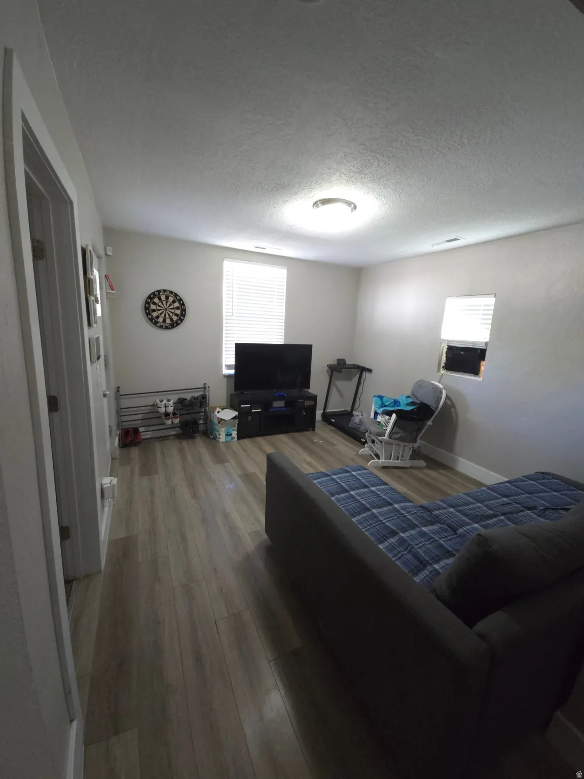 Recessed ceiling light, wood-finish flooring, and window with blinds