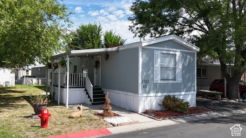 Light blue siding exterior with white trim and a covered front porch
