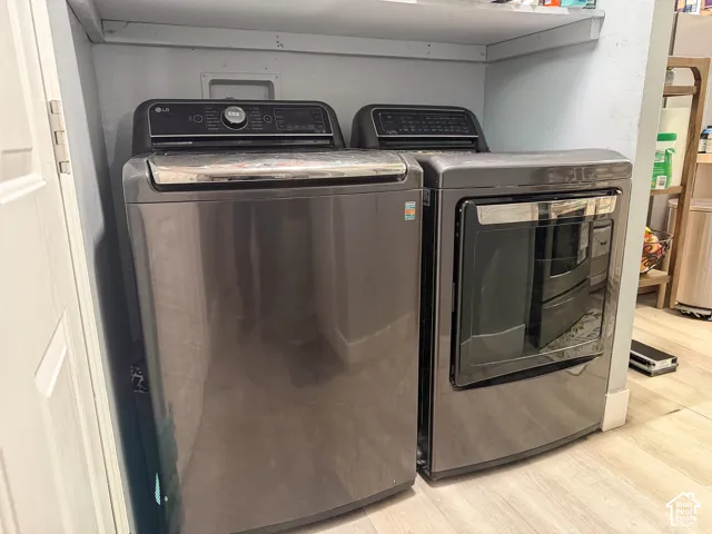 Dedicated laundry area with light wood-finish flooring