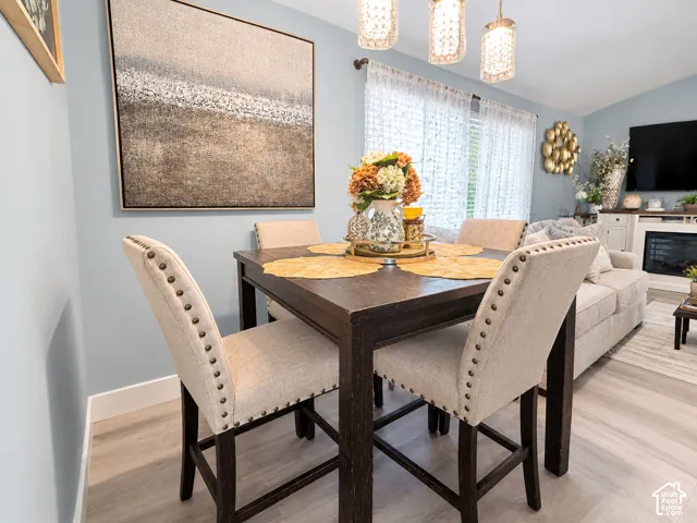 Open-concept living space featuring wood-finish flooring, recessed lighting, and a built-in fireplace