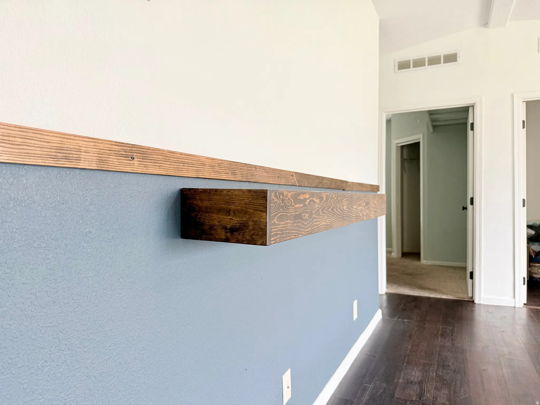 Floating wood-finish shelf with a wood accent wall trim