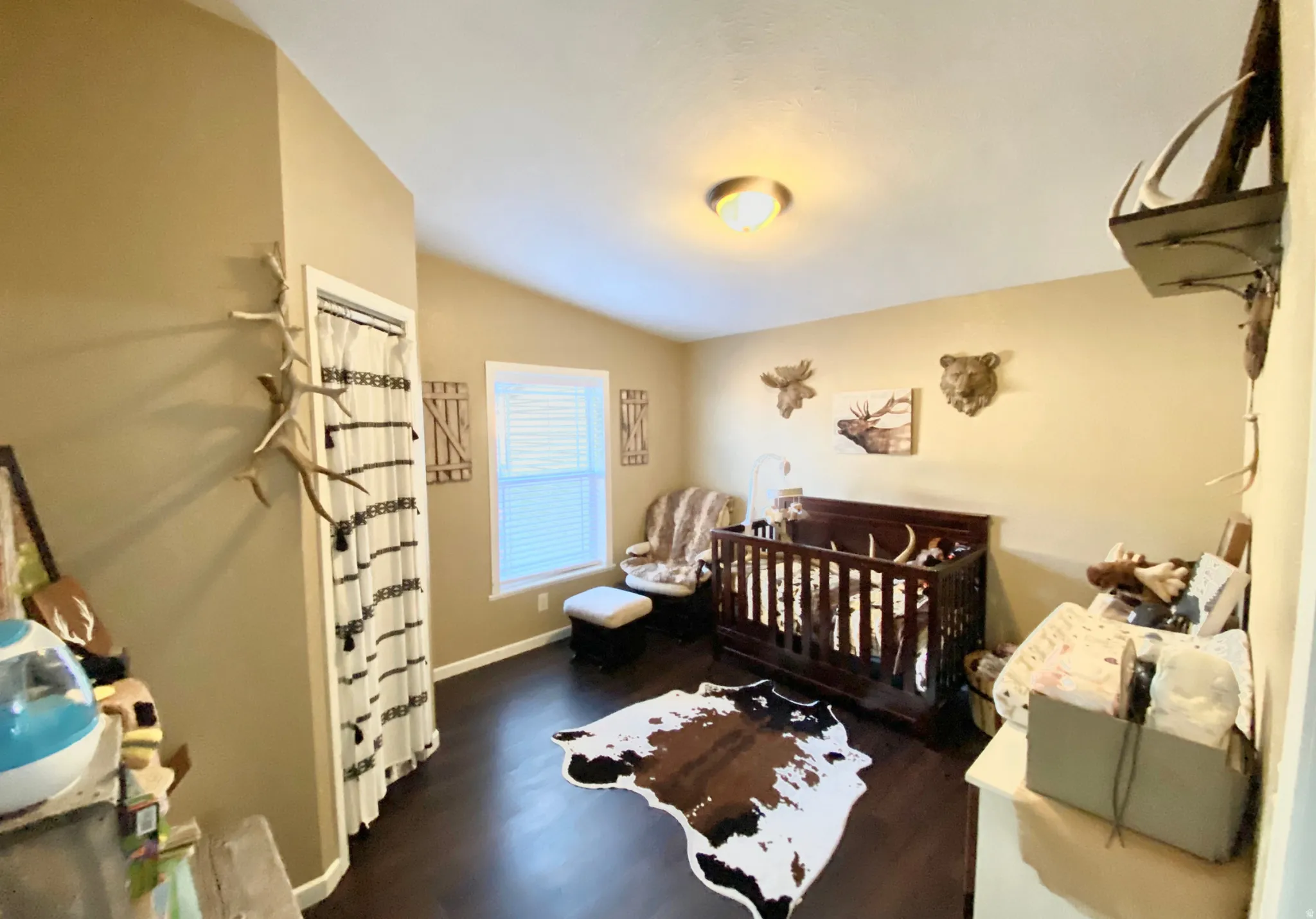 Vaulted ceiling, single window with blinds, wood-finish flooring, and recessed lighting