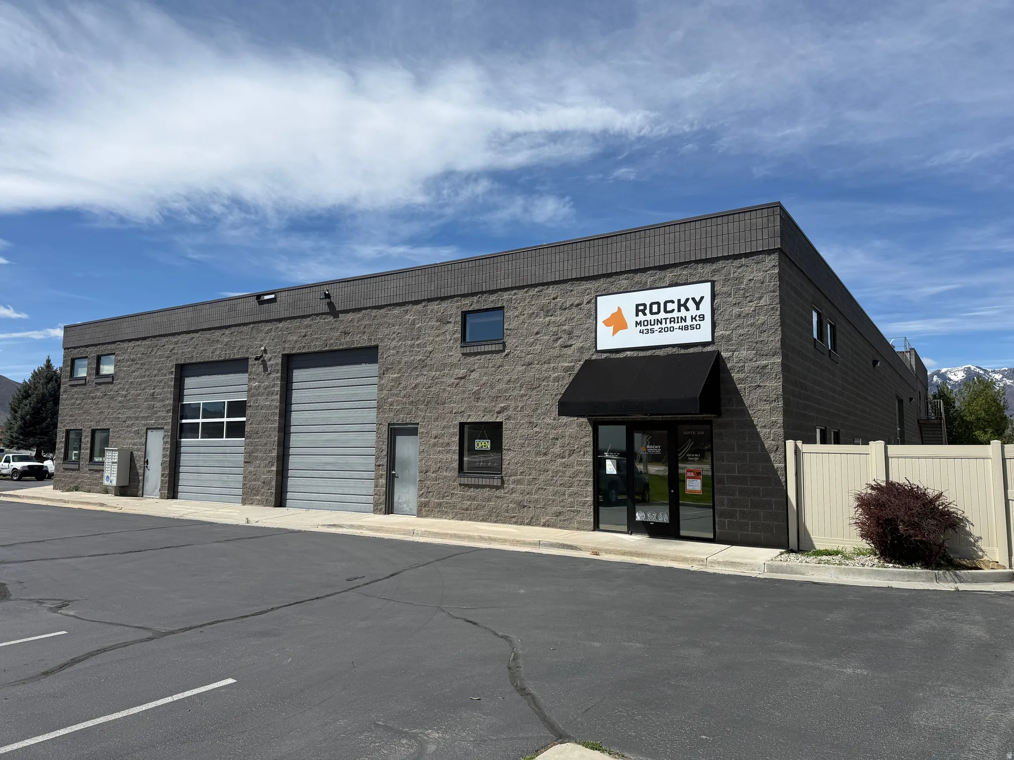 Commercial building featuring a stone block exterior and multiple garage doors