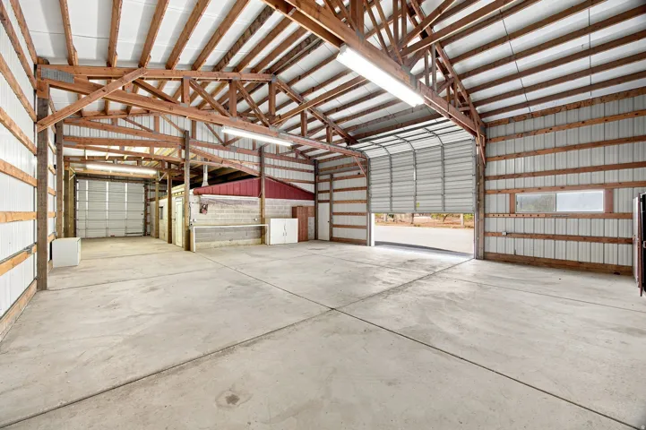 Expansive concrete flooring with exposed wood beam ceiling