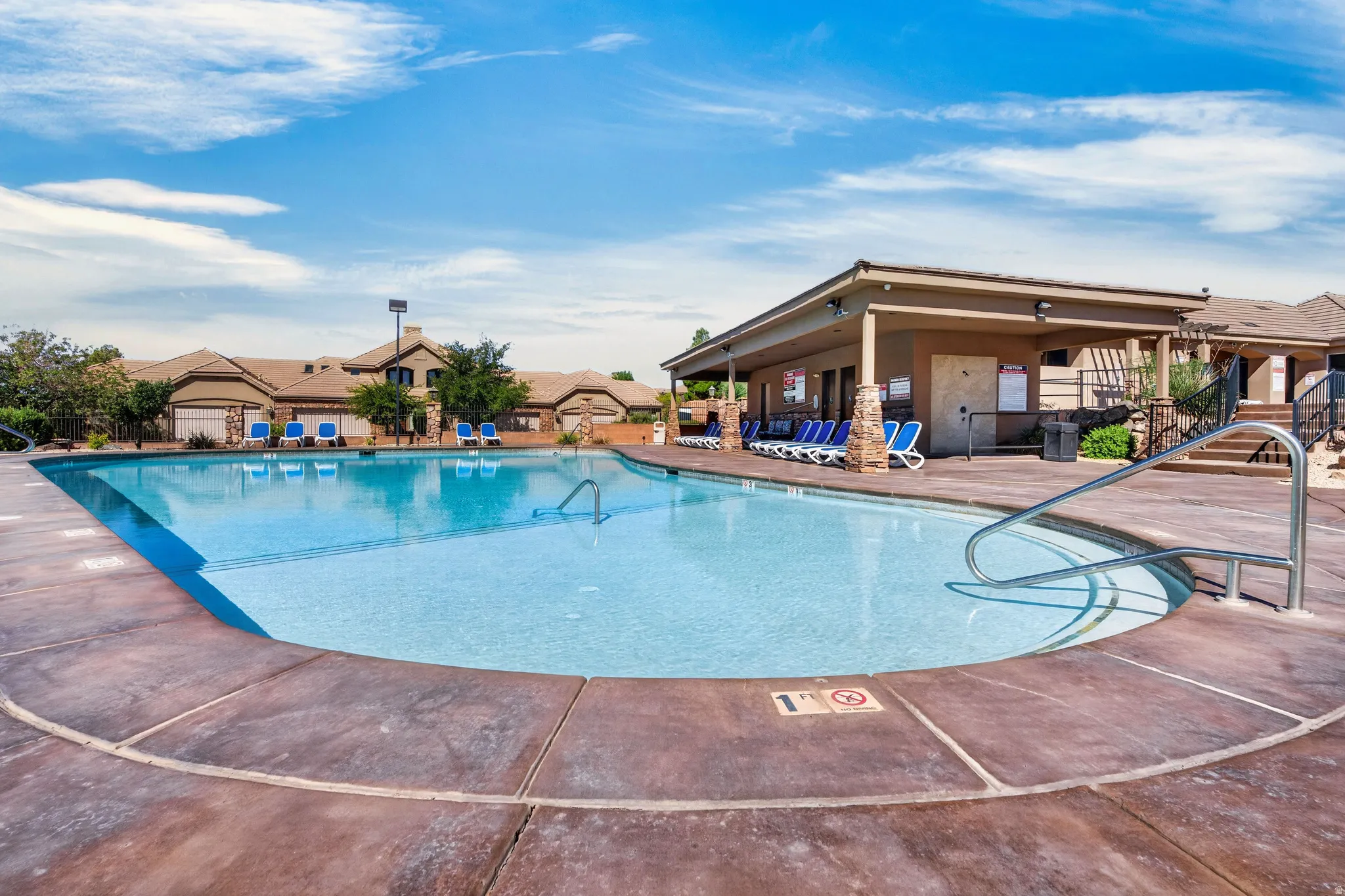 Two pools and two spas with a large, covered patio for relaxation and shade