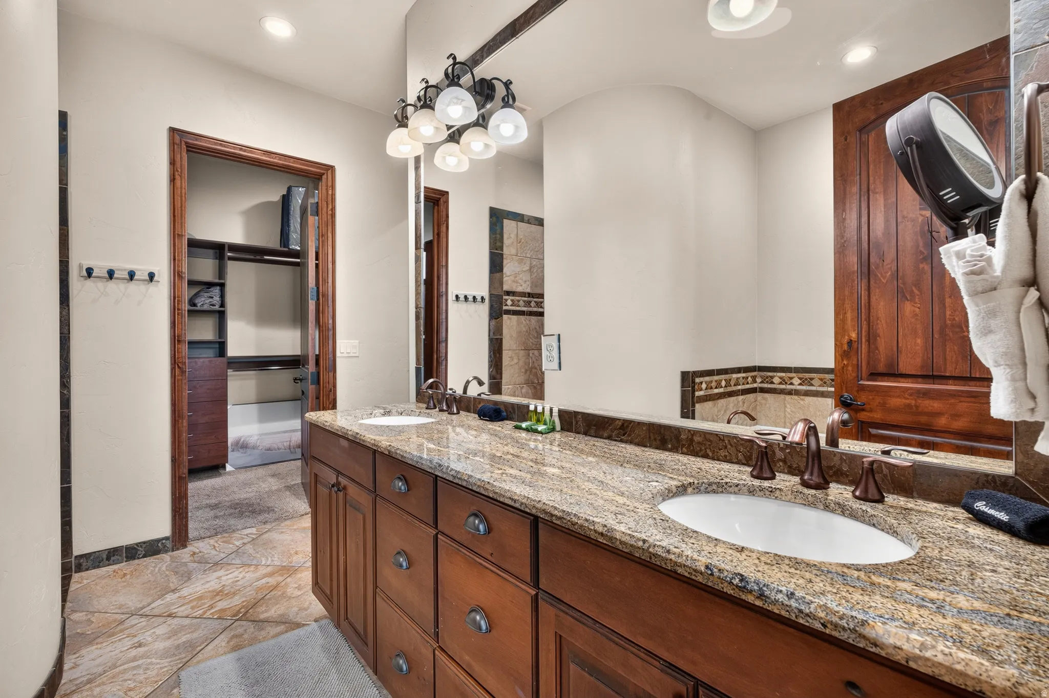 Dual vanity with a stone countertop and integrated sinks