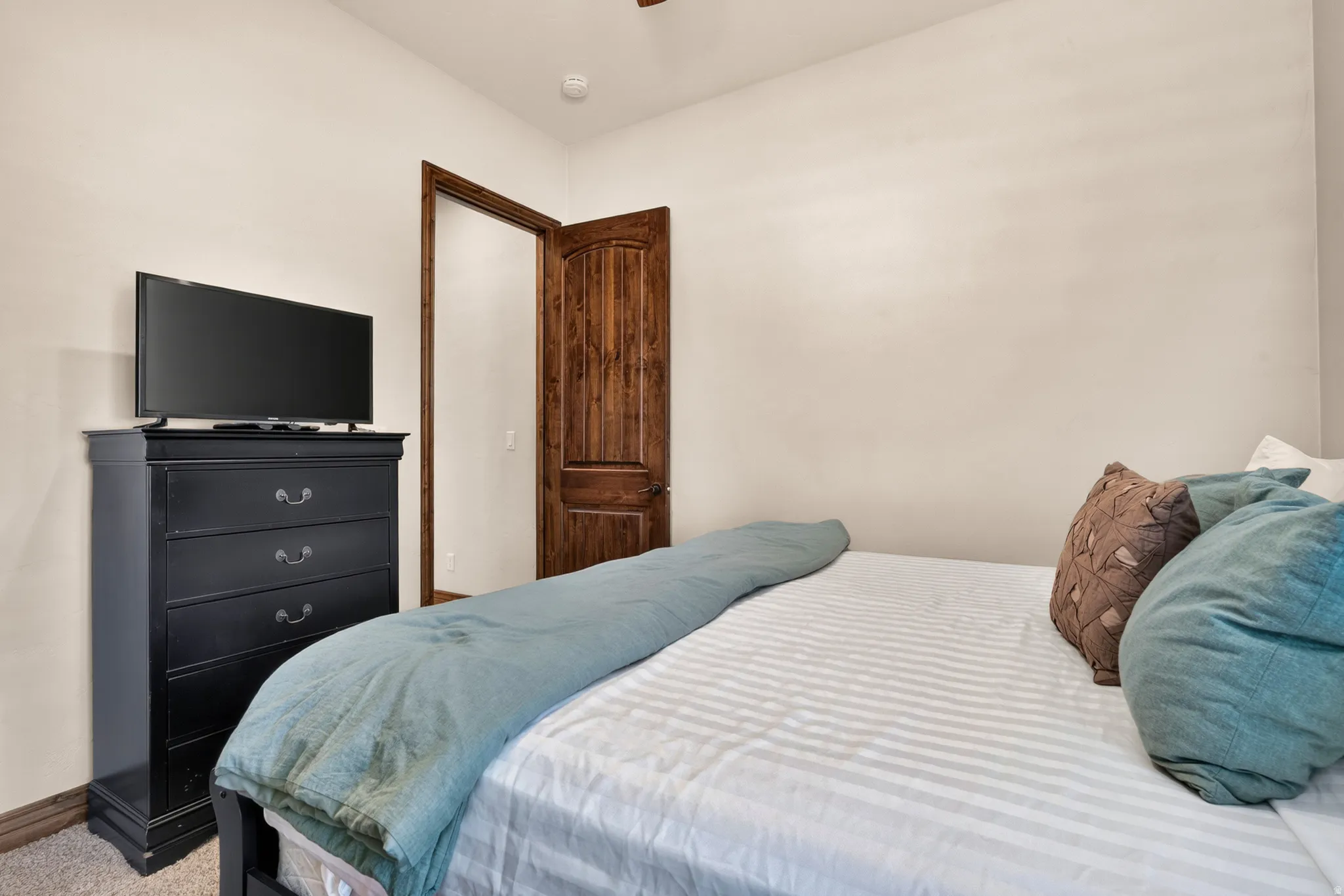 Wood-finish interior door with dark hardware