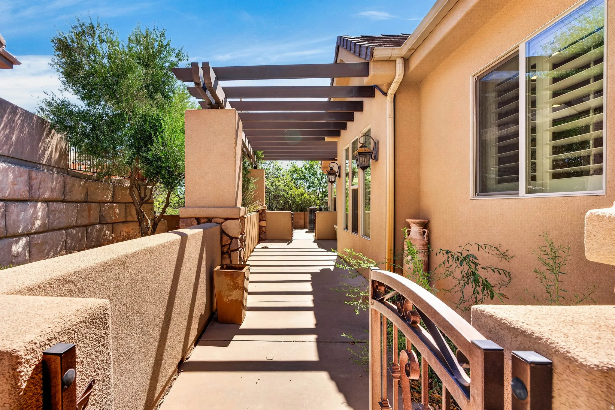 Stucco exterior with an attached pergola