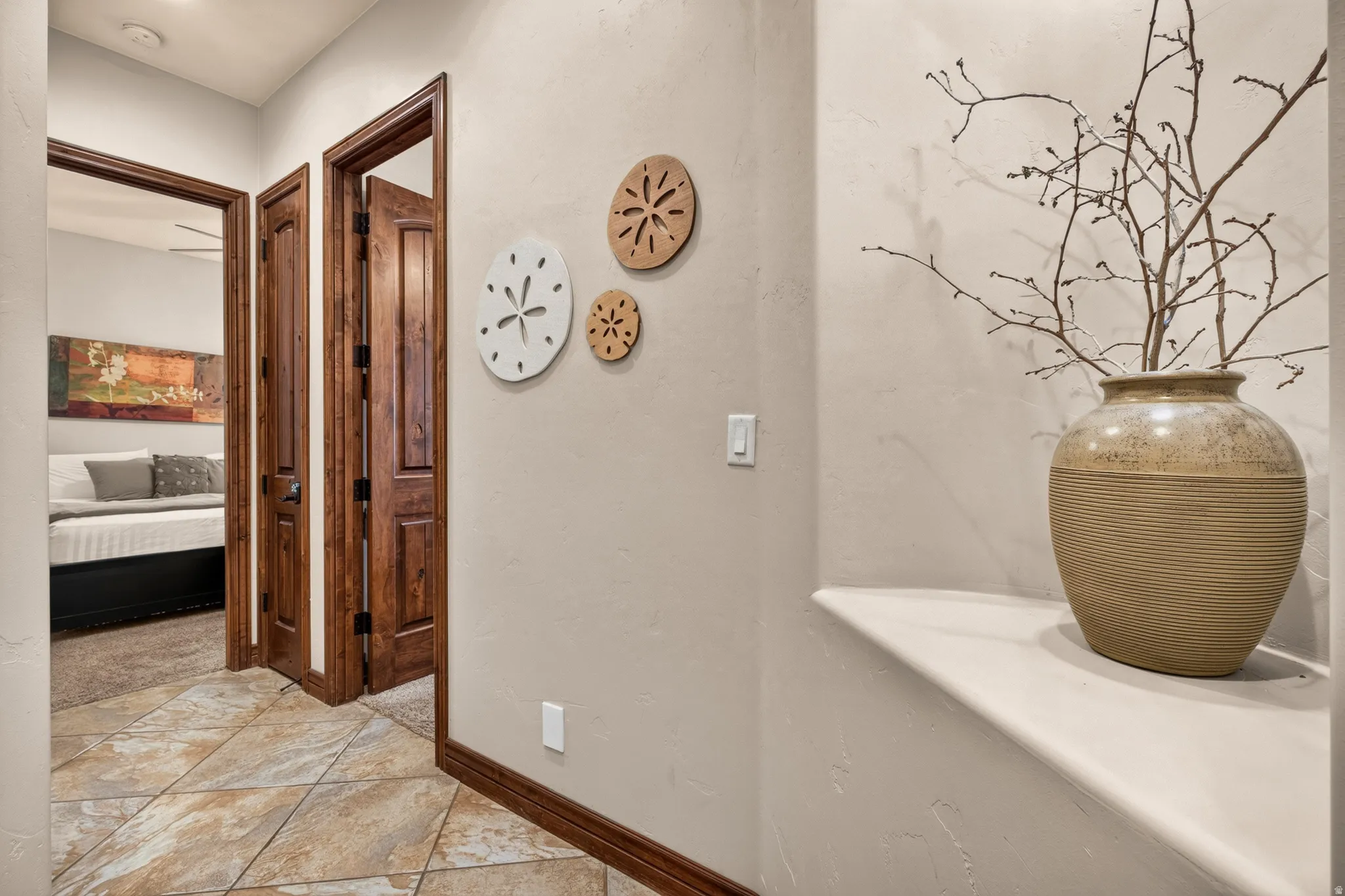 Textured wall finish, built-in display niche, tiled flooring, solid wood panel doors, ceiling fan
