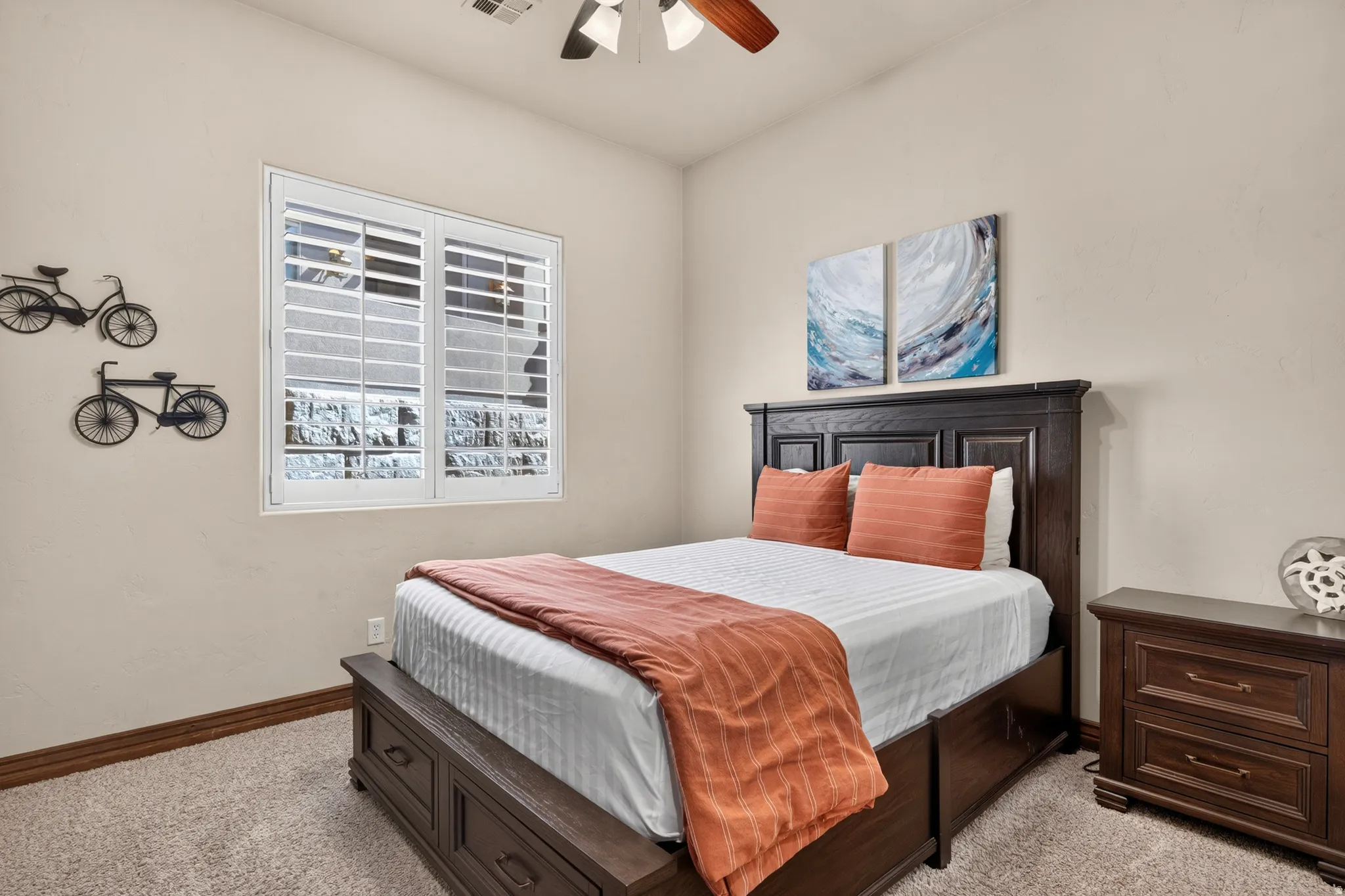 Window with plantation shutters and ceiling fan