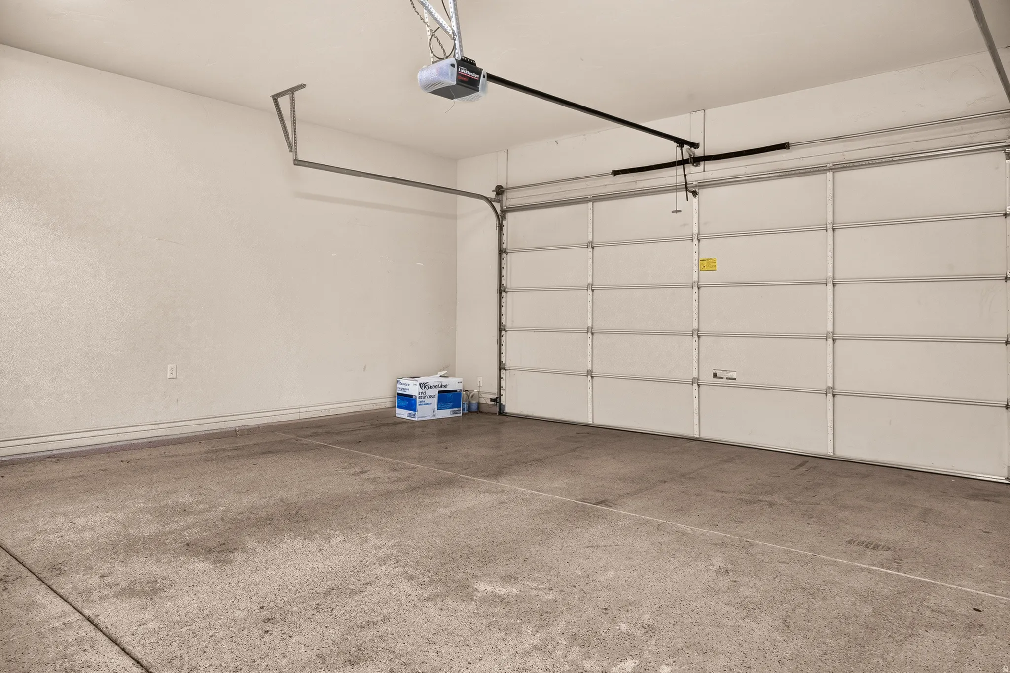 Attached garage with concrete flooring and an automatic overhead door