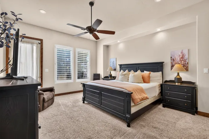 Recessed lighting, ceiling fan, carpeted flooring, and window shutters