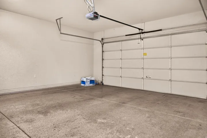 Attached garage with concrete flooring and an automatic overhead door