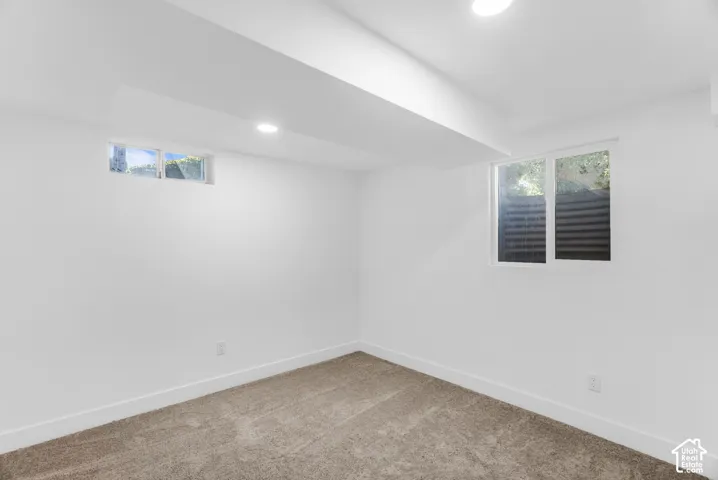 Fourth bedroom with recessed lighting, white walls, two windows, and neutral carpeting