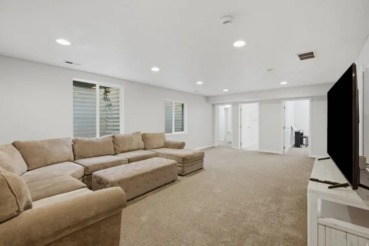 Recessed lighting, light-toned carpeting, multiple egress windows, and white interior doors
