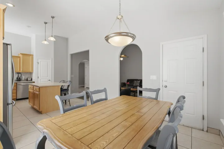 Kitchen featuring wood-finish cabinetry, stainless steel appliances, and a tiled backsplash