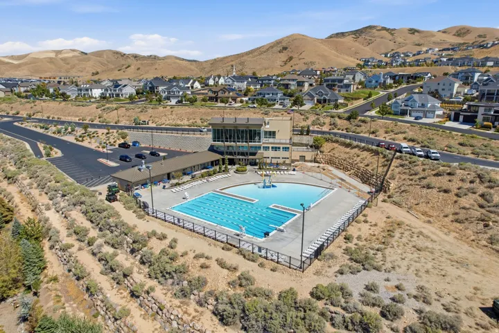 Expansive outdoor swimming pool with integrated lap lanes and a diving board