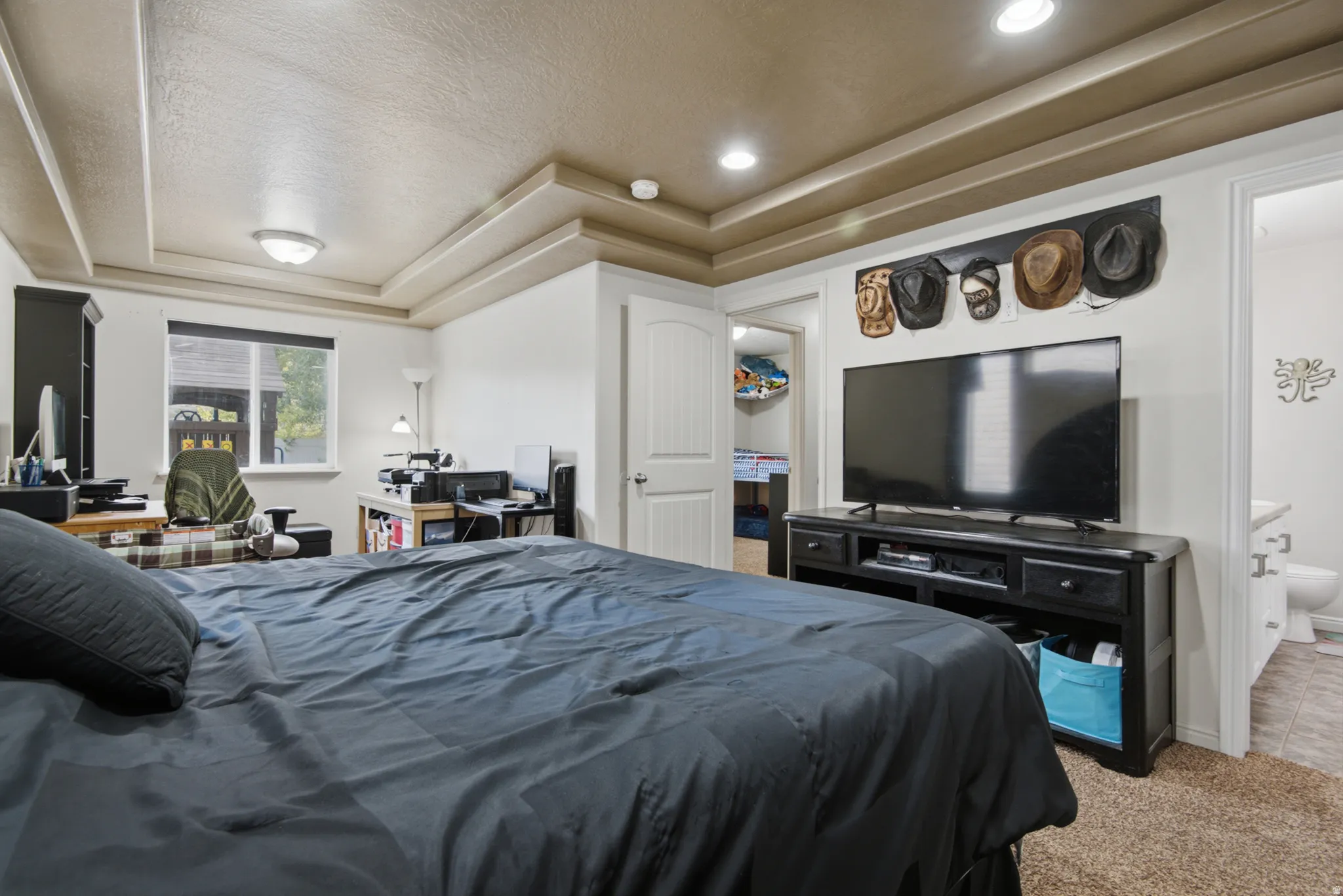 Recessed lighting, tray ceiling, and a large window