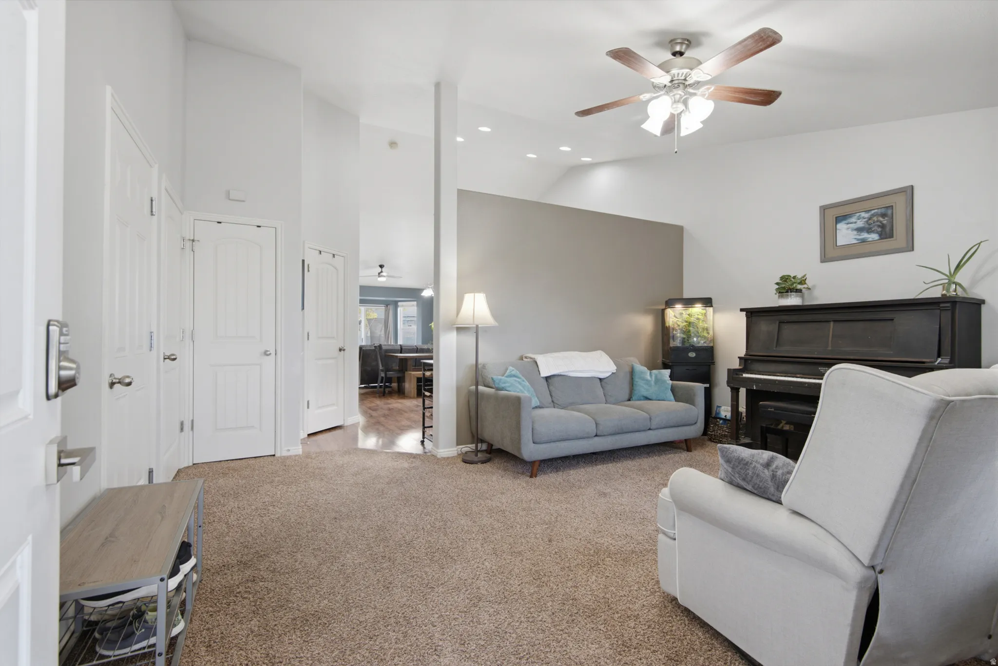 Vaulted ceilings with recessed lighting and a ceiling fan, plush carpet flooring, and white interior doors