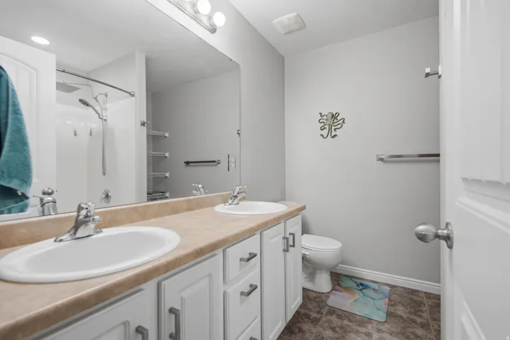 Dual vanity with undermount sinks, white cabinetry, and brushed nickel hardware