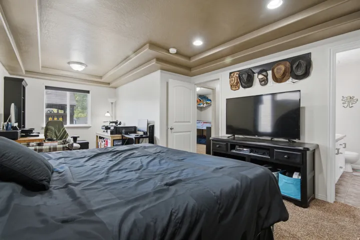 Recessed lighting, tray ceiling, and a large window