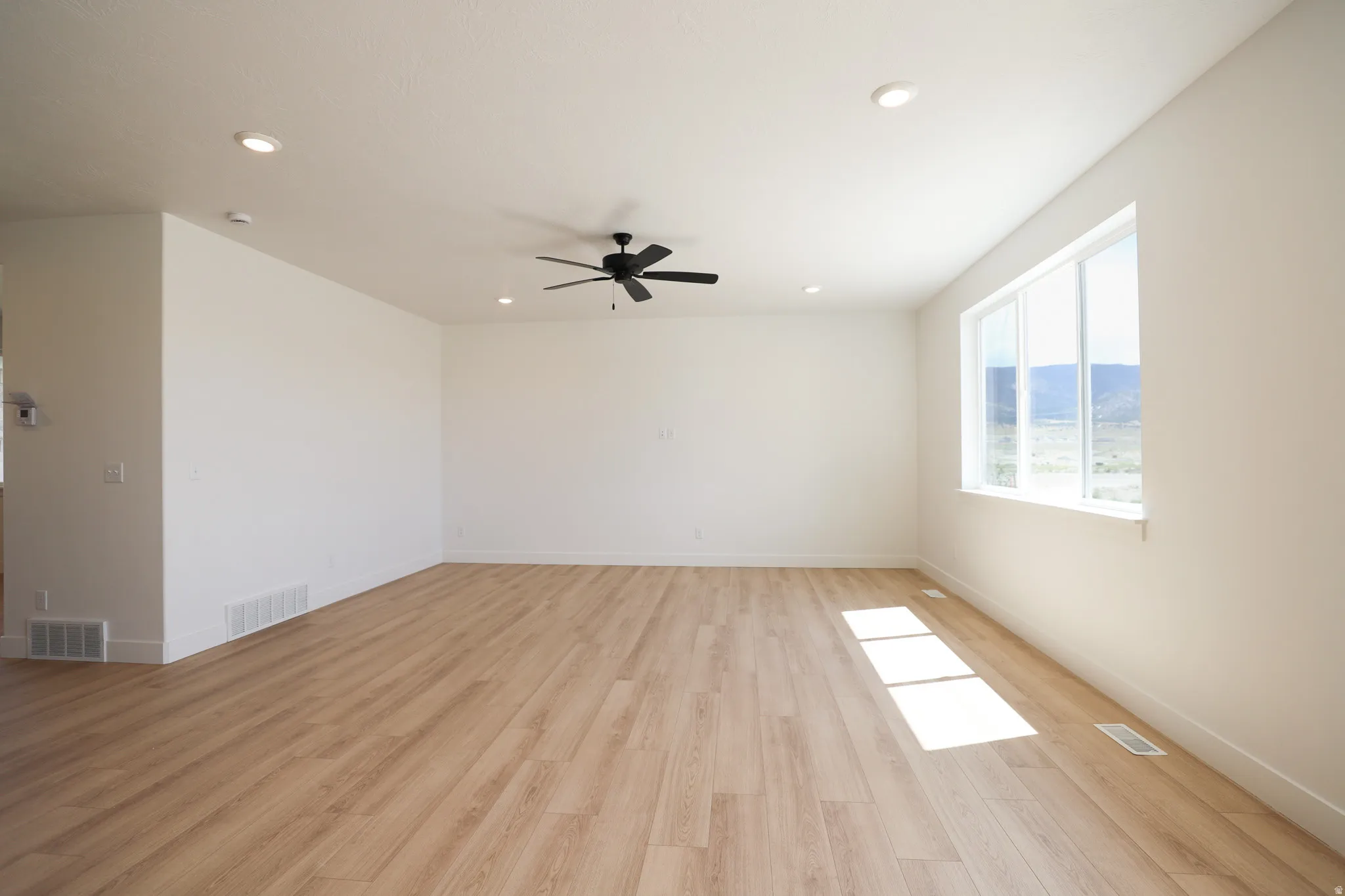Huge family room with picture windows, 9' ceiling and ceiling fan.