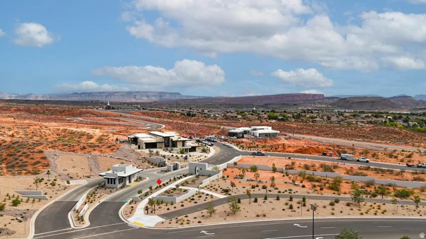 Gated community entry with a multi-lane roadway and contemporary guardhouse structures