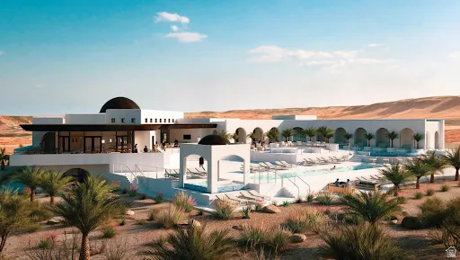 Mediterranean-style architecture with domed roofs, multiple tiered swimming pools, extensive outdoor lounging areas, and natural desert landscaping