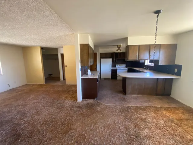 Kitchen featuring wood-finish cabinetry, a U-shaped countertop, and a breakfast bar