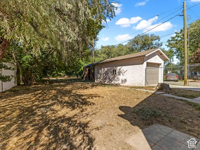 Detached garage with stucco exterior and roll-up door