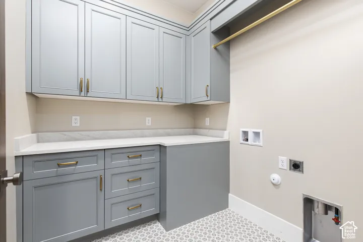 Light gray cabinetry with gold-tone hardware