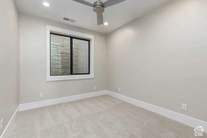 Recessed lighting, ceiling fan, white trim, light-toned walls, and carpet flooring