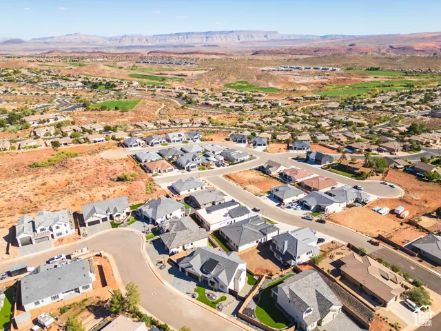 Aerial perspective of a residential community featuring varied architectural styles and surrounding natural landscapes