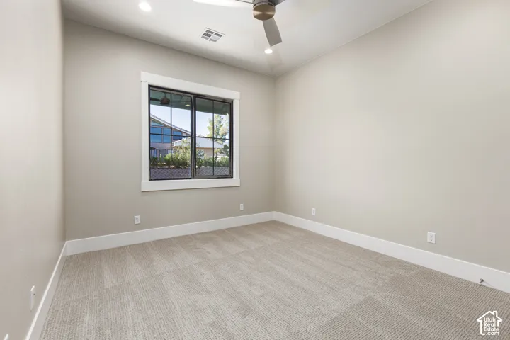 Wall-to-wall carpeting, window with dark frame, recessed lighting, and a ceiling fan