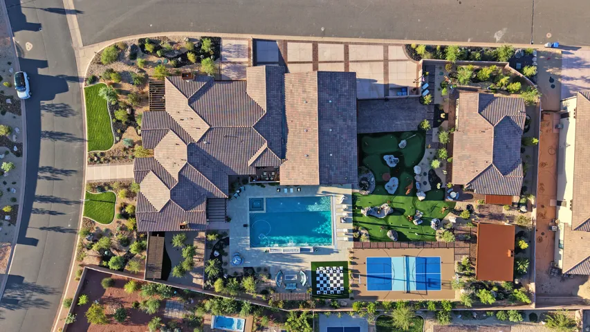 Expansive property featuring a large swimming pool, a dedicated sports court, a putting green, and a giant chess board
