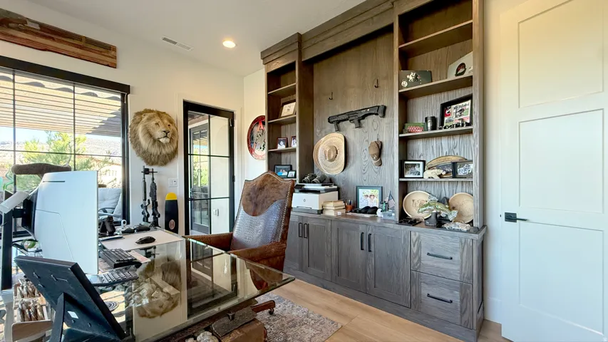 Custom built-in cabinetry with shelving, solid core interior door, and French pane exterior door