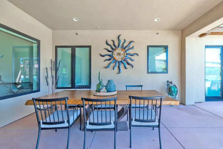 Covered patio featuring recessed lighting, a smooth stucco exterior, and multi-pane windows with dark frames
