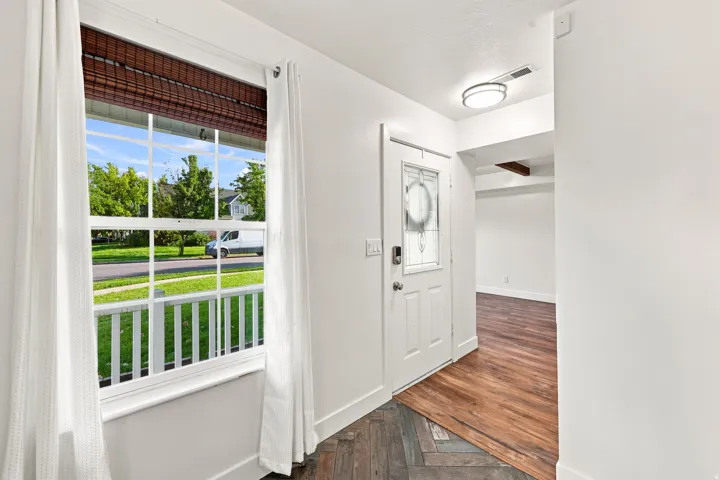 White paneled entry door with decorative glass insert