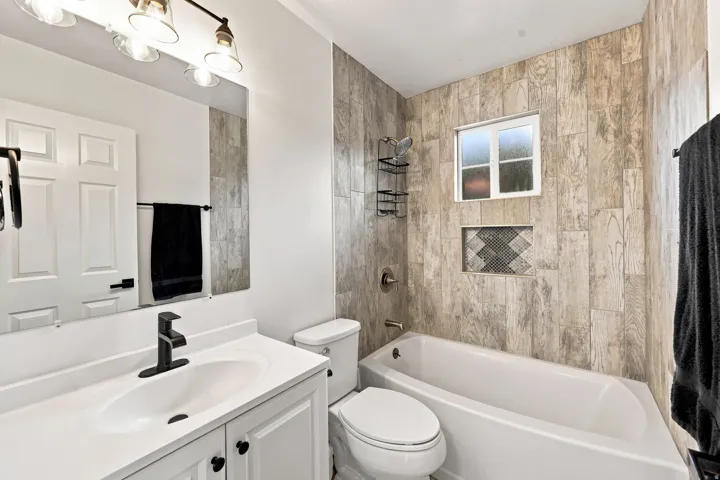 White vanity with black hardware and a sleek black faucet