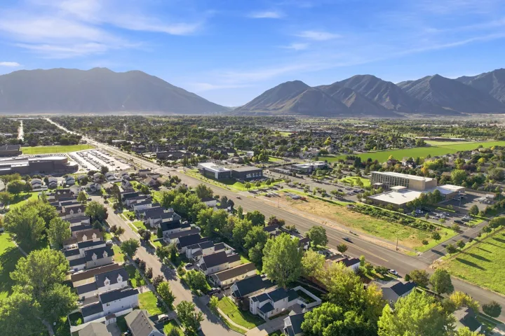 Expansive mountain backdrop with a developed residential area featuring tree-lined streets and established structures