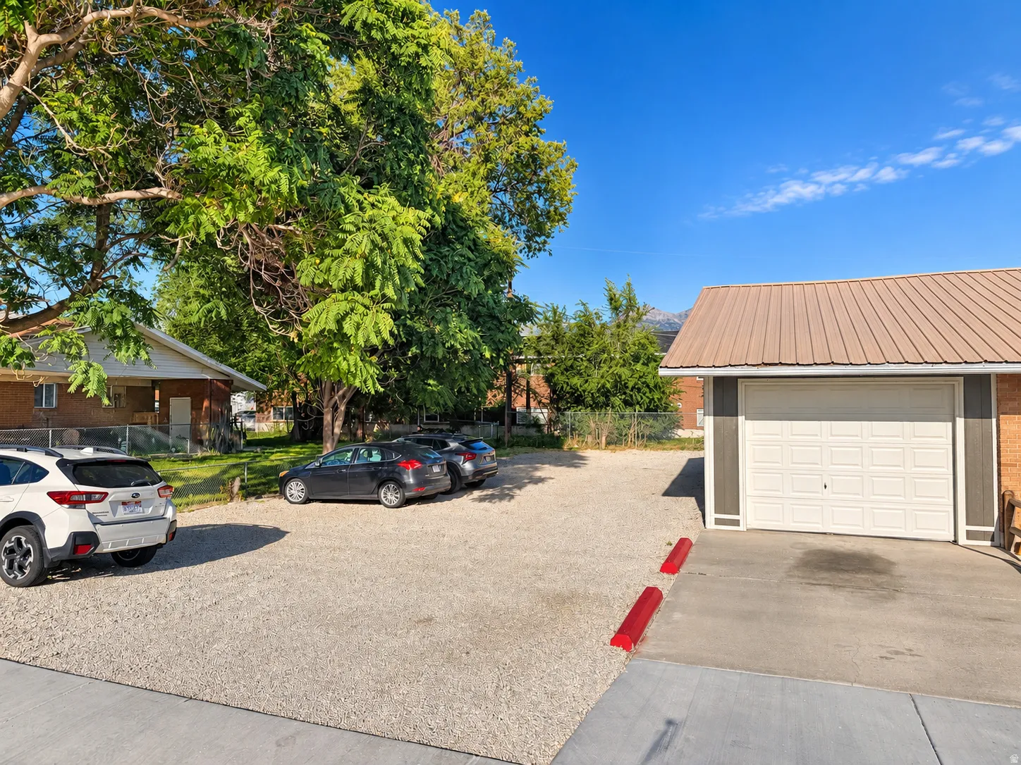 Detached single-car garage featuring a metal roof and panel garage door