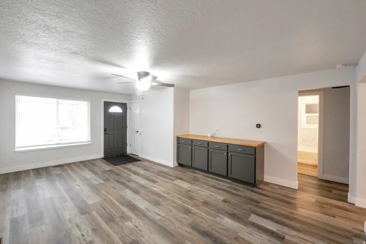 Wood-finish flooring, recessed lighting, and a ceiling fan